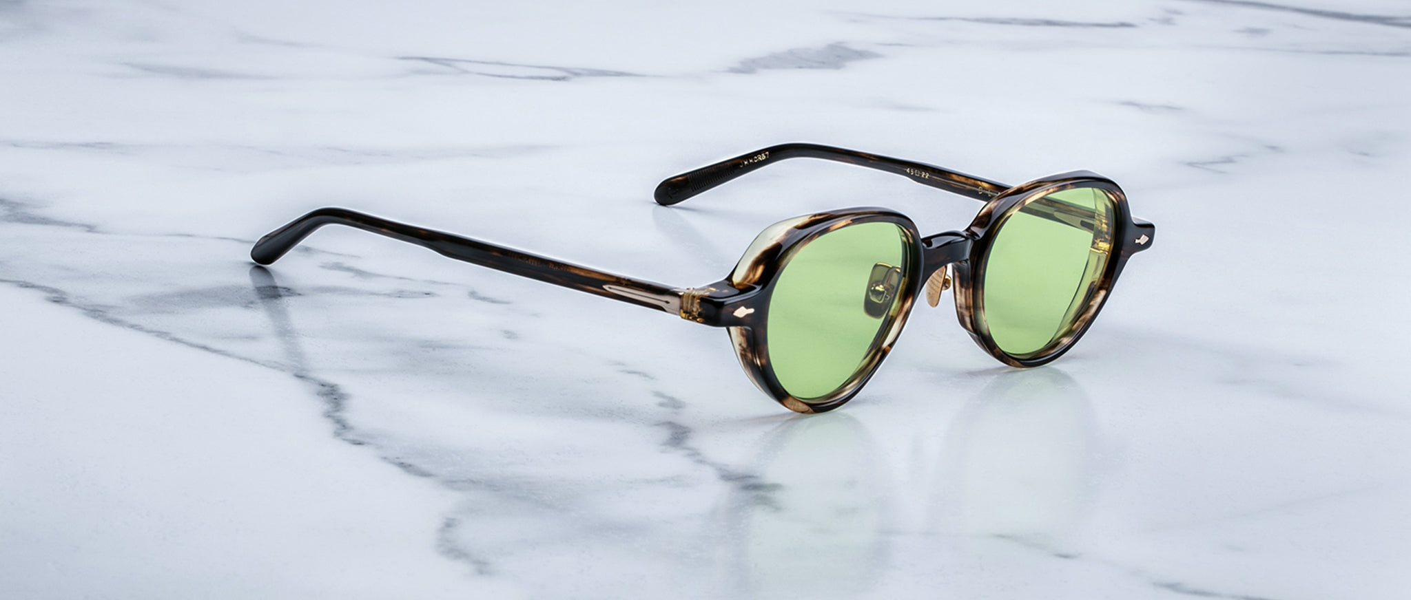 Jacques Marie Mage The Clark tortoiseshell sunglasses with green lenses, viewed from above.