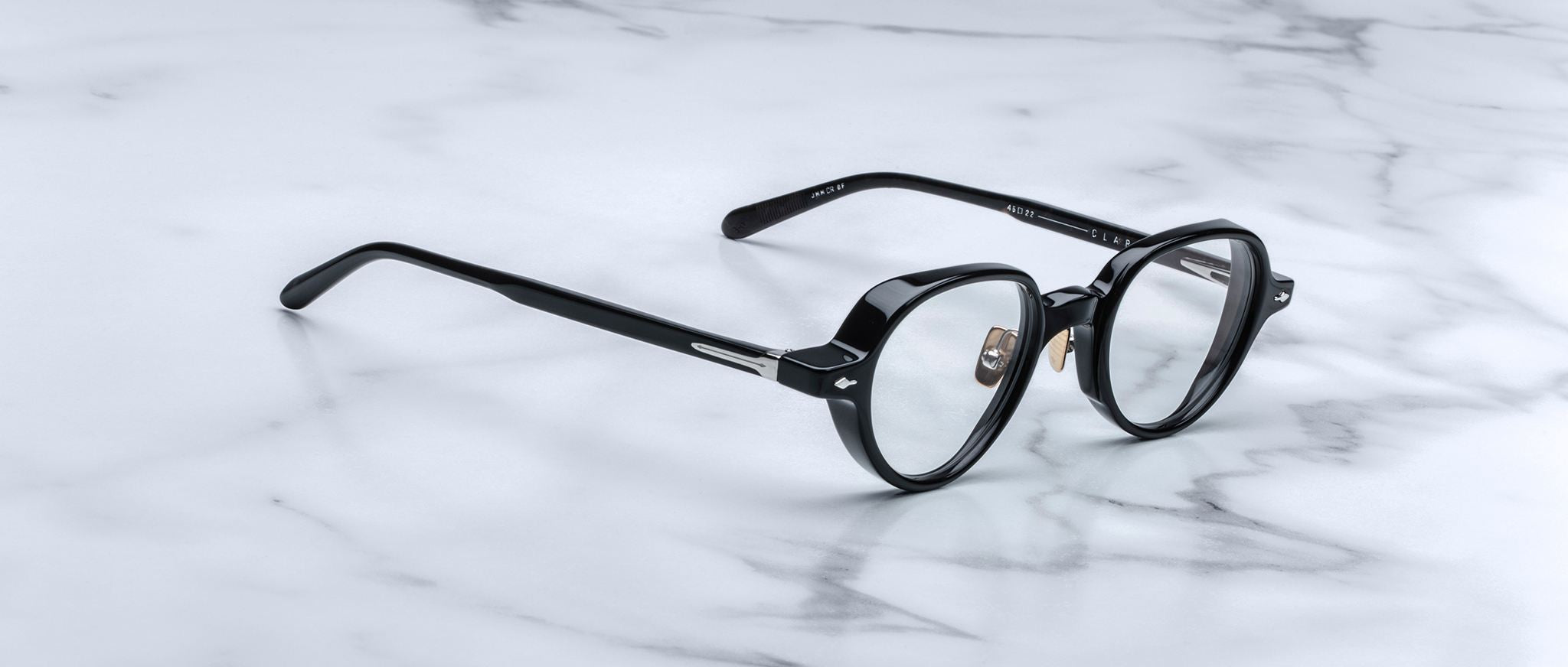 Jacques Marie Mage The Clark eyeglasses with clear lenses, shown from above, featuring full-rim frames.