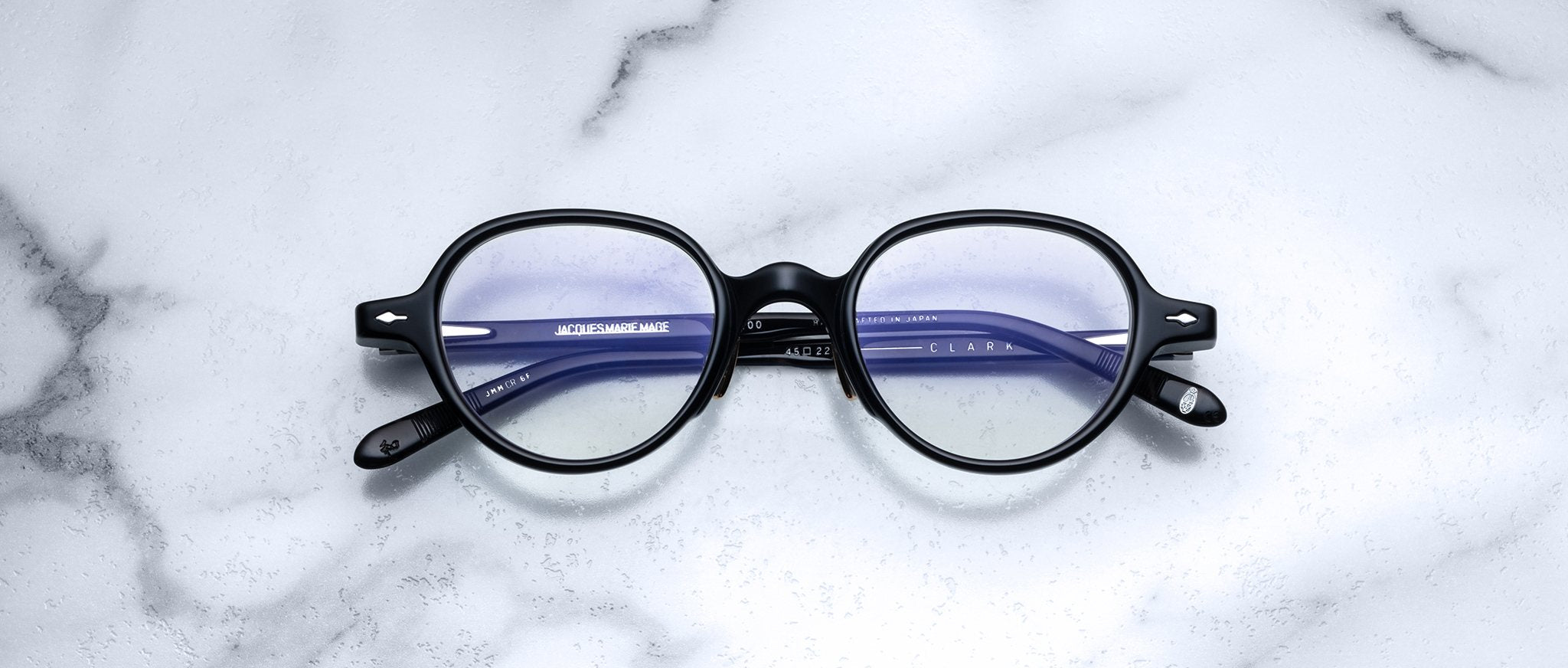 Jacques Marie Mage The Clark eyeglasses with blue-tinted lenses, viewed from above, showing full frames and temples.
