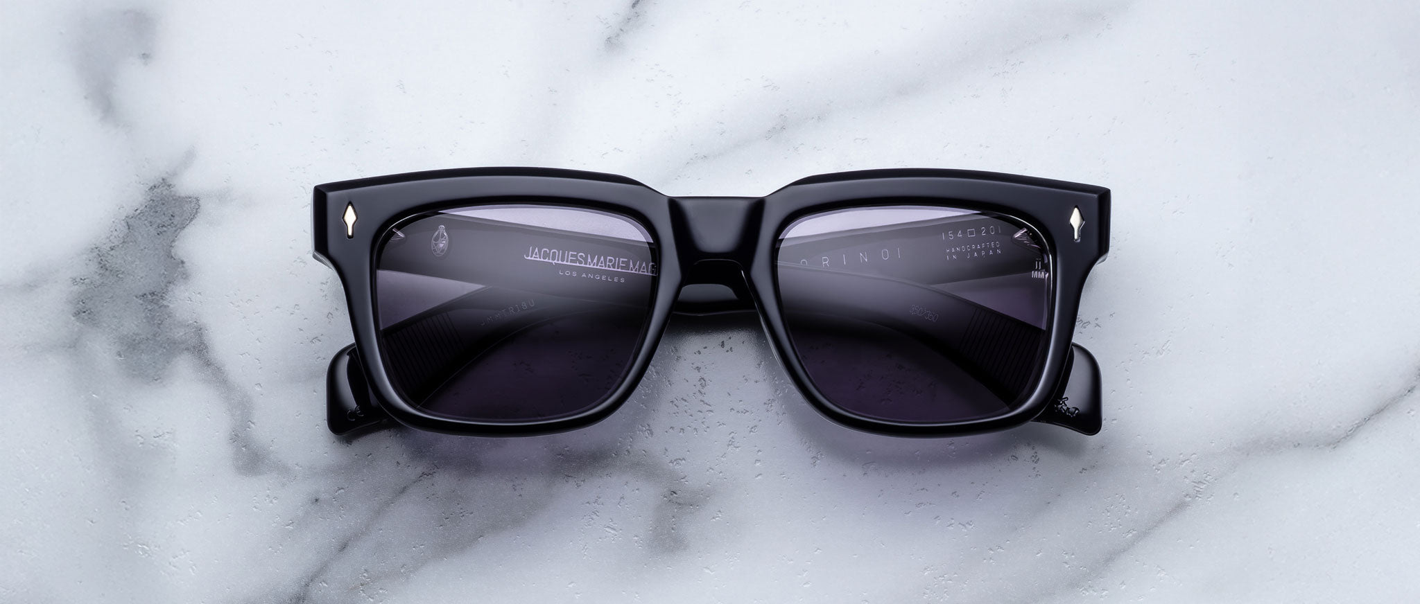 Jacques Marie Mage Torino in Hudson rectangular dark blue sunglasses with dark lenses, top-view angle.