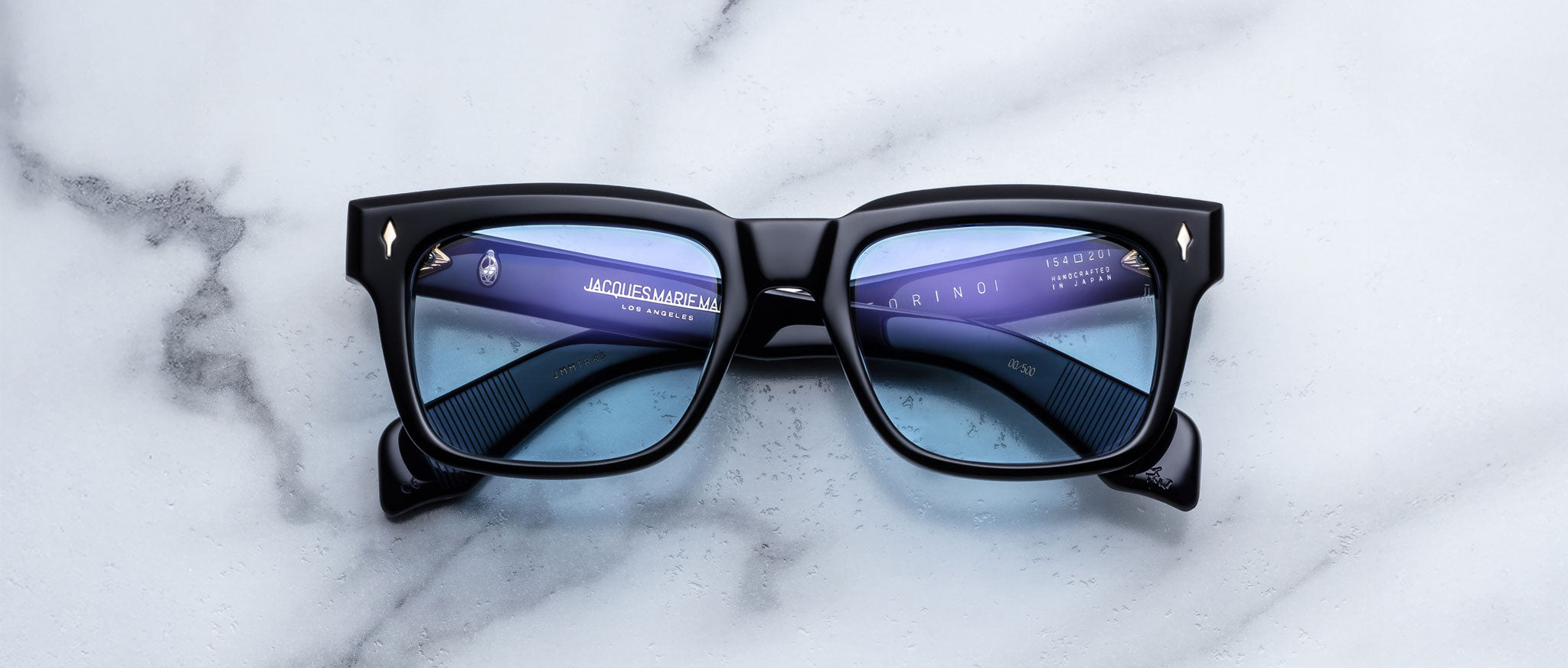 Jacques Marie Mage Torino in Obscure black rectangular eyeglasses with blue-tinted lenses, front view.