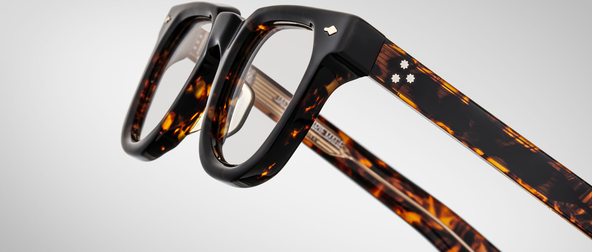 Close-up of Jacques Marie Mage Vendome eyeglasses with thick tortoiseshell rims and silver details on the temples.