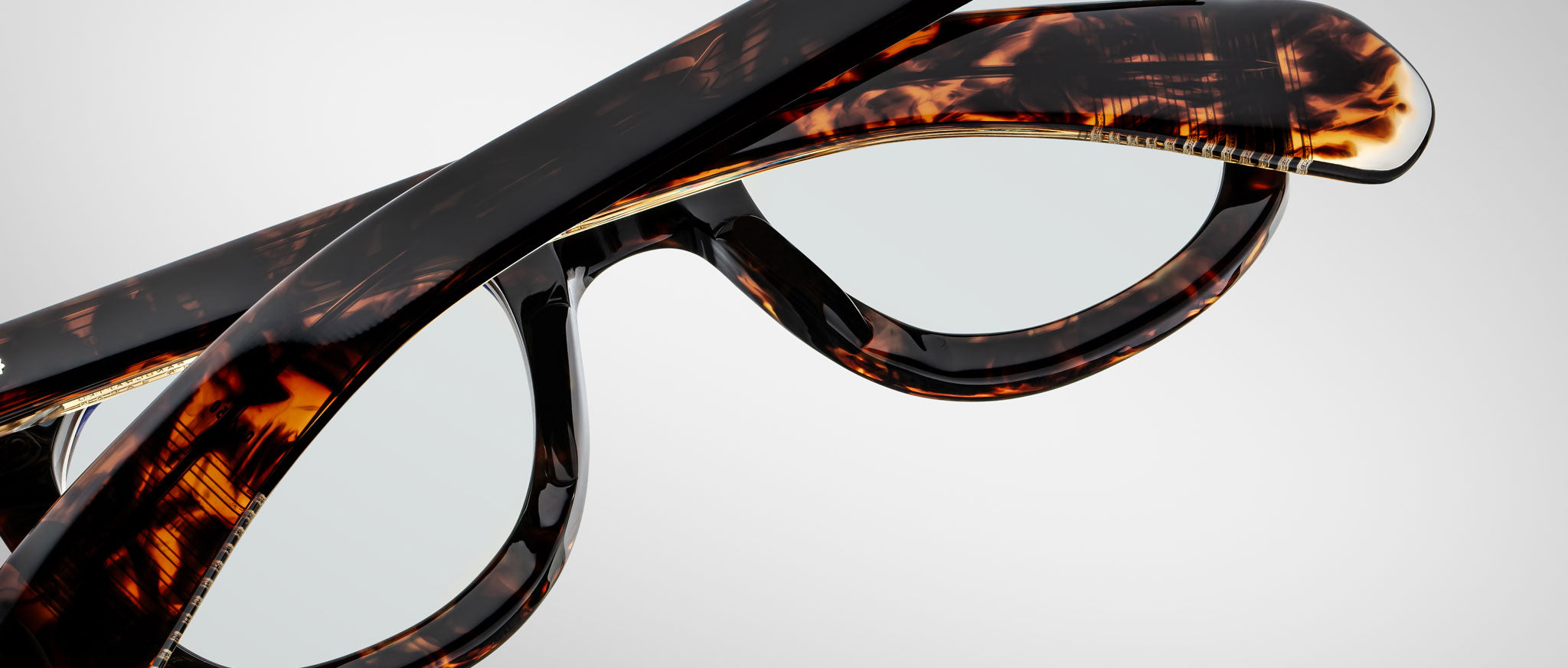 Close-up angle of Jacques Marie Mage Vendome tortoiseshell eyeglasses with arms folded, showing the frames vintage style.