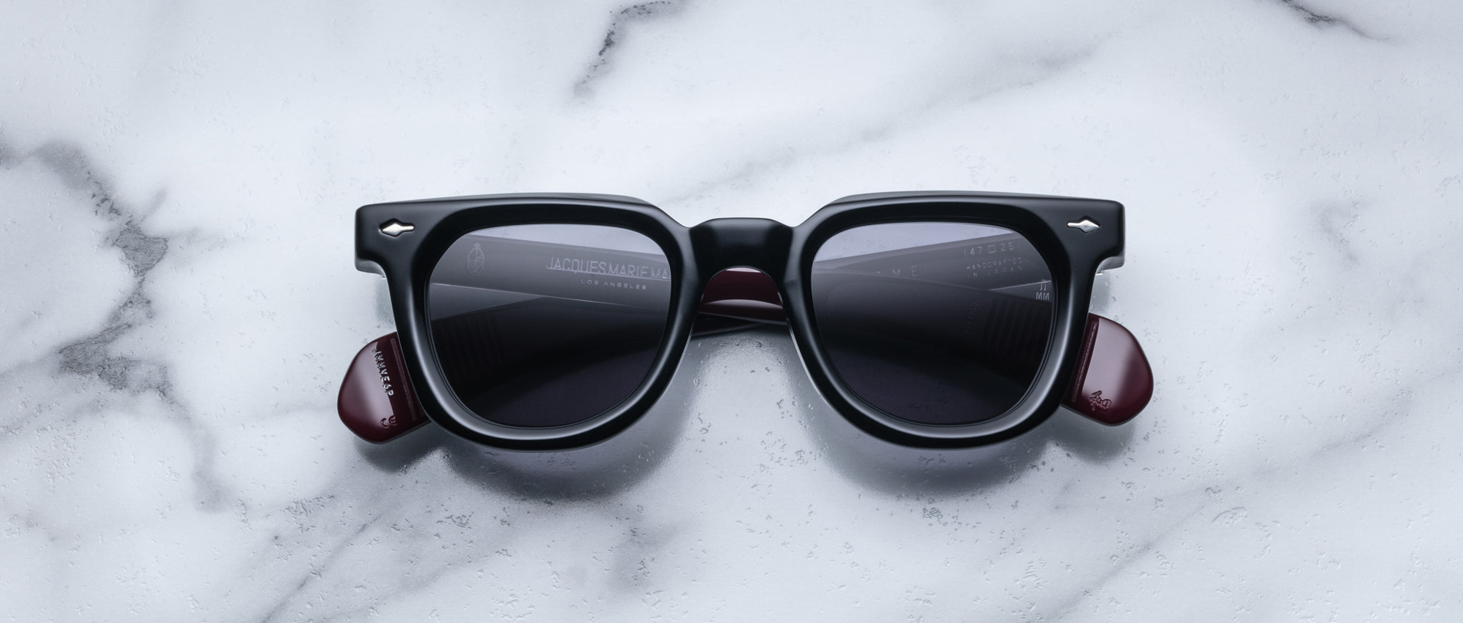 Jacques Marie Mage Vendome sunglasses with maroon temple tips, viewed from above, showing full frame and design details.