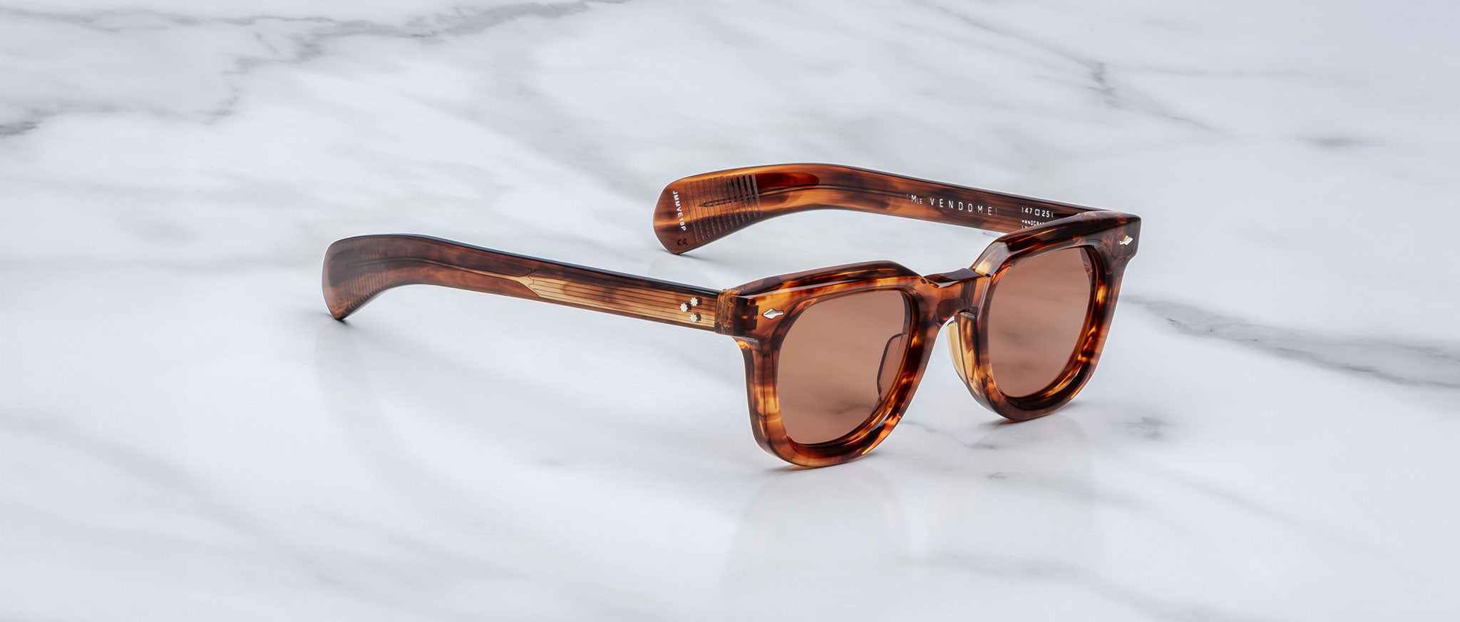 Jacques Marie Mage Vendome sunglasses with tinted lenses, front view, displayed on a surface.