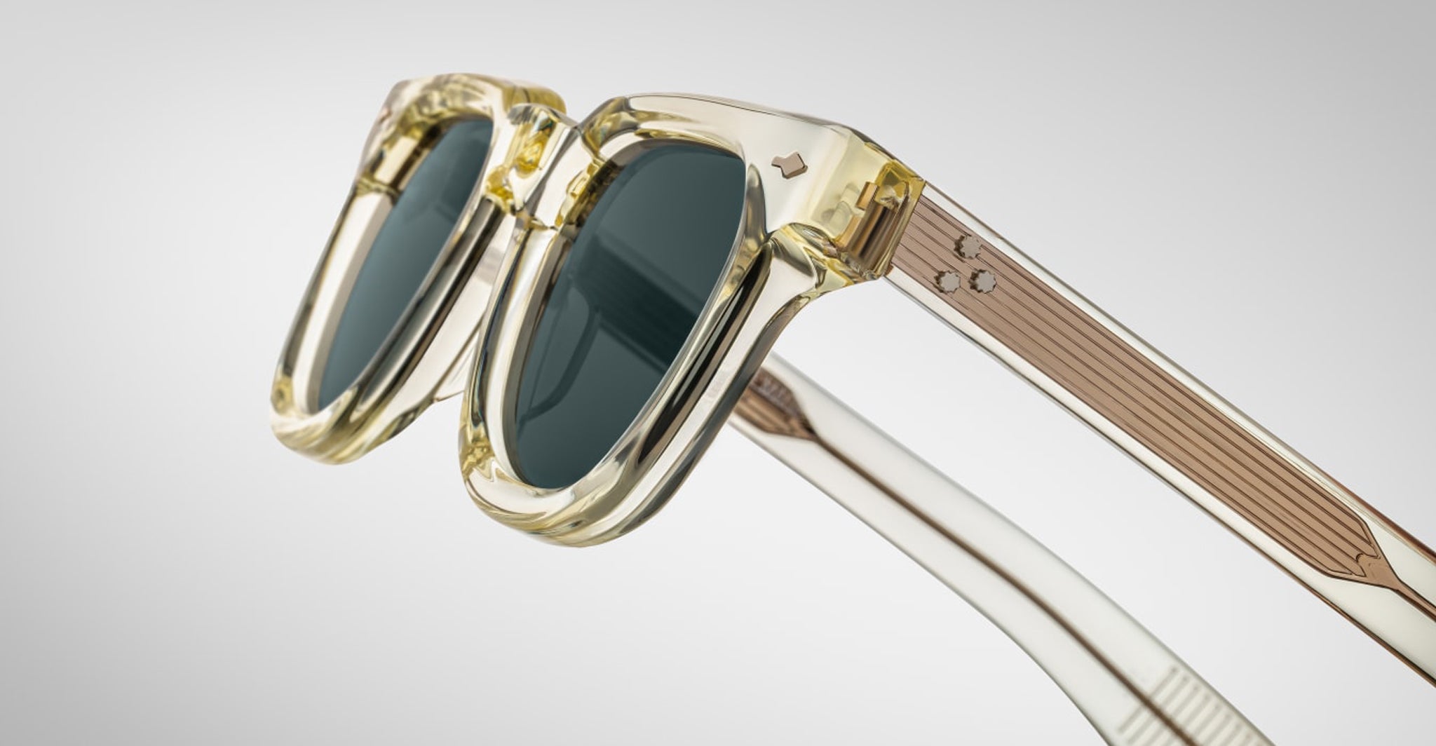 Close-up of Jacques Marie Mage Vendome sunglasses: translucent beige, thick frames, dark lenses. Expertly handcrafted in Japan by Jacques Marie Mage, shown against a plain light background.