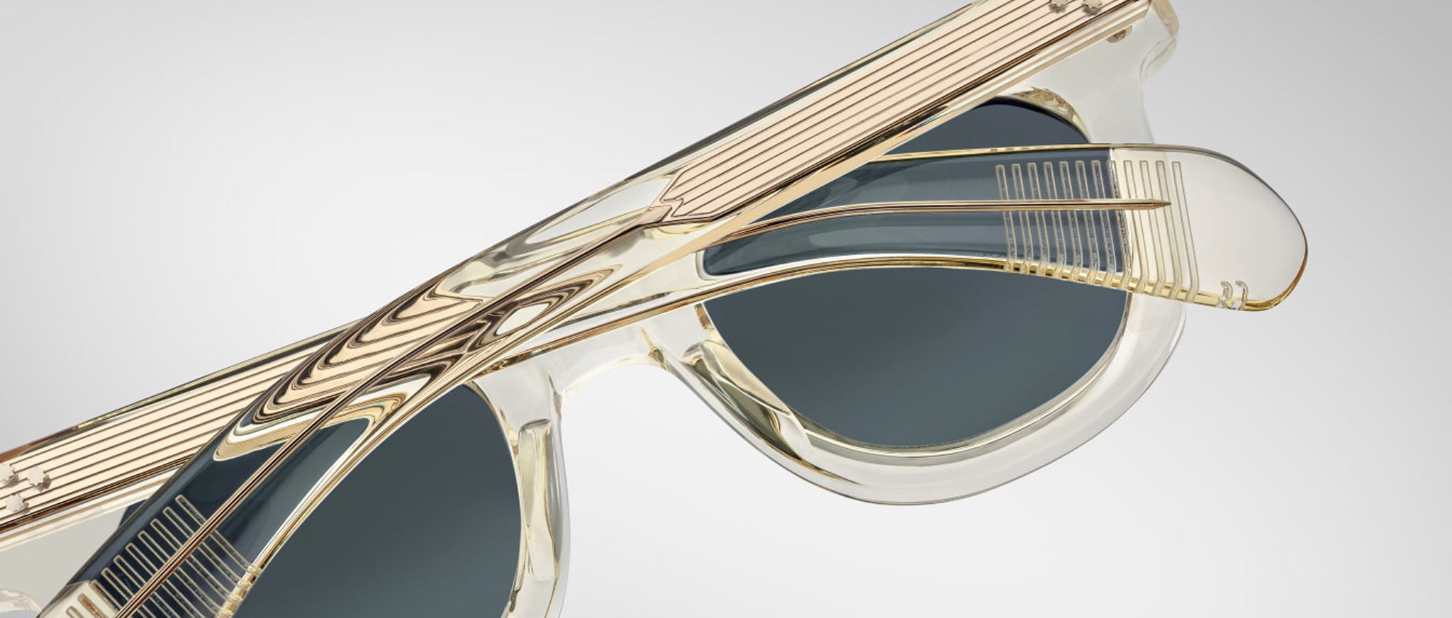 Close-up of Jacques Marie Mage Vendome sunglasses, folded, featuring dark lenses and gold accents.