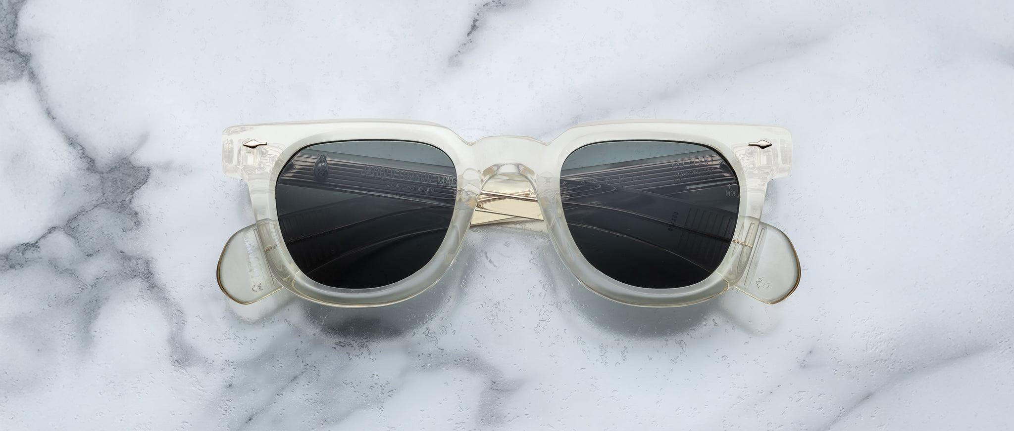 Jacques Marie Mage Vendome clear-frame sunglasses with dark lenses shown from above.