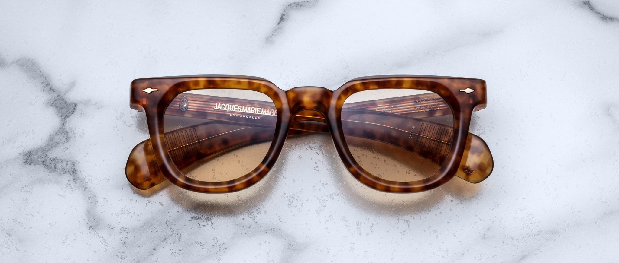 Jacques Marie Mage Vendome sunglasses with brown lenses, top-down view.