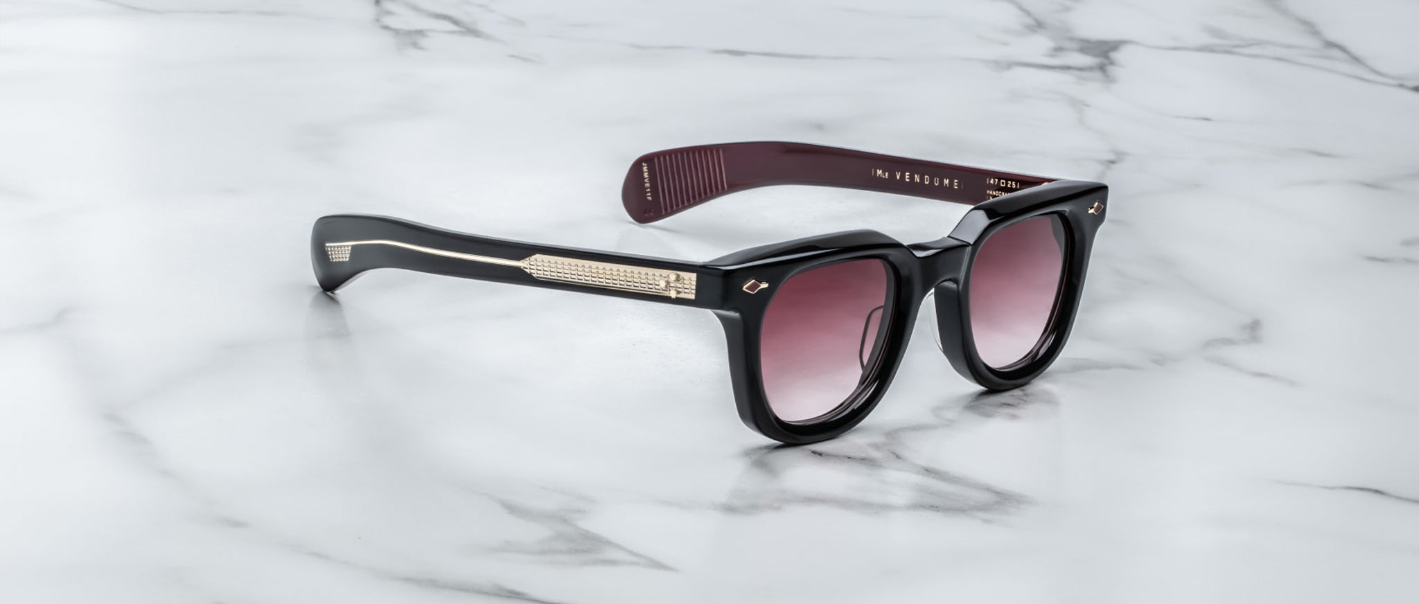 Jacques Marie Mage Vendome black sunglasses with gold accents and gradient lenses, shown from the front angle.