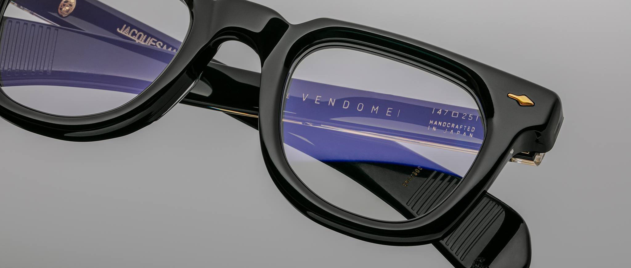 Close-up view of Jacques Marie Mage Vendome black eyeglasses, highlighting lens reflections and handcrafted frame details.