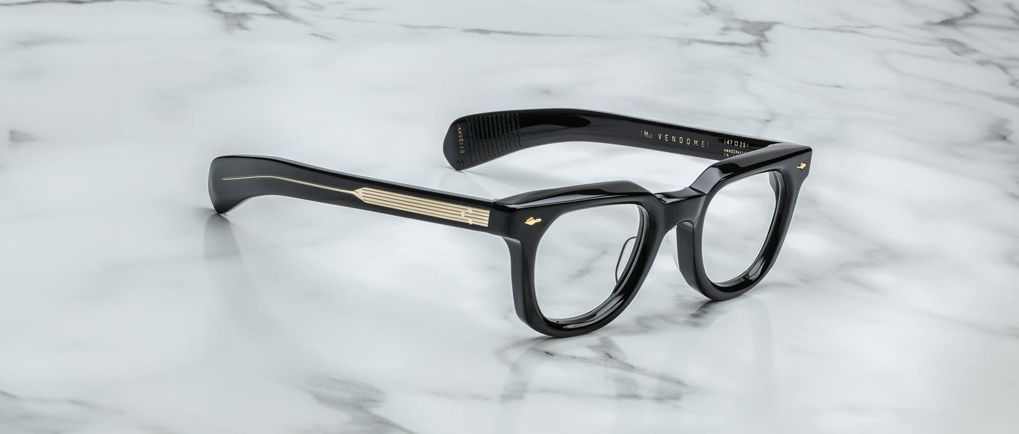 Jacques Marie Mage Vendome black eyeglasses with thick frames and gold temple accents, viewed from above.