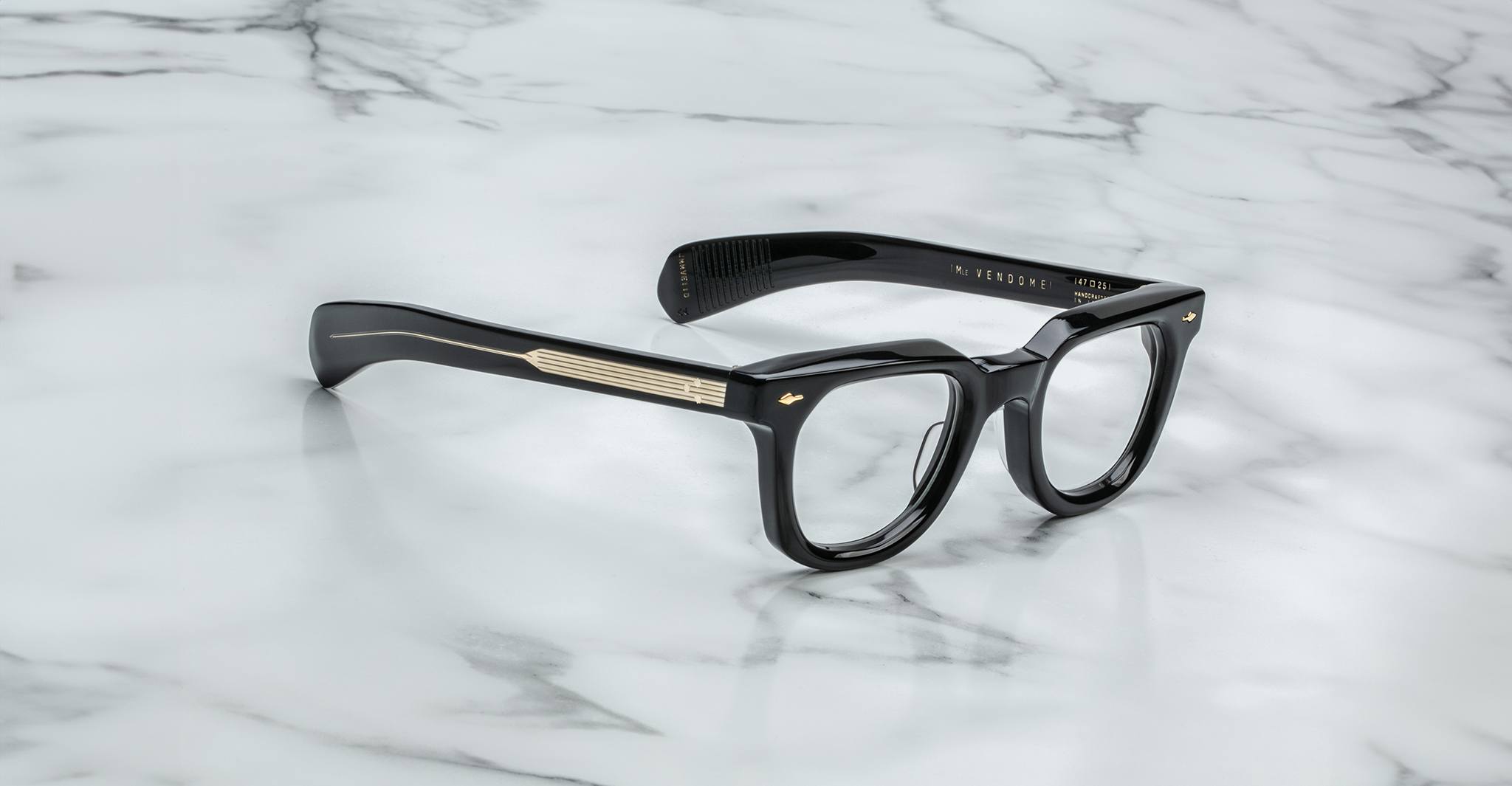 Jacques Marie Mage Vendome black rectangular optical frames with gold arm detailing, handcrafted in Japan, displayed on white marble.