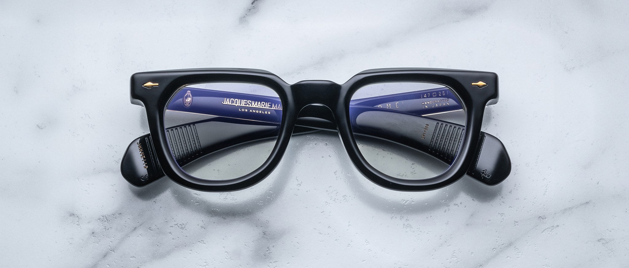 Jacques Marie Mage Vendome black eyeglasses with thick frames, side arms and lens reflection visible, shown from a top view.