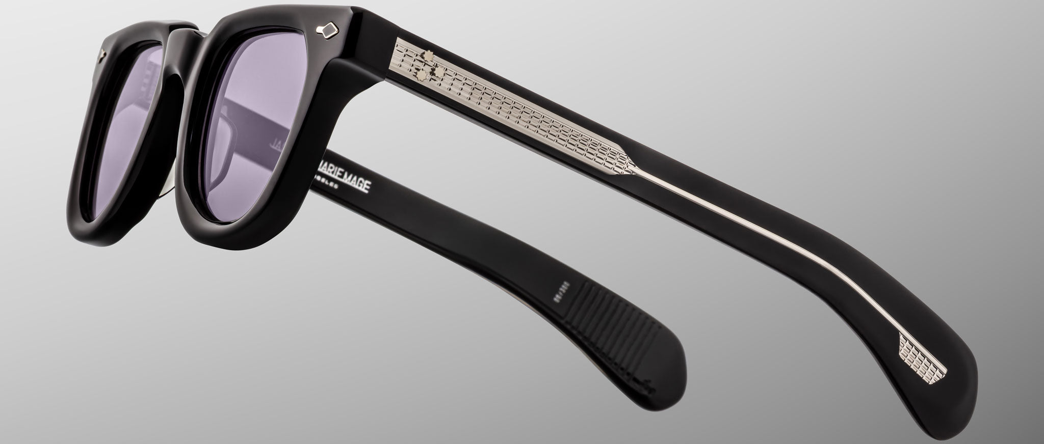 Jacques Marie Mage Vendome sunglasses with thick black frames, silver arm accents, and purple lenses shown from the front angle.