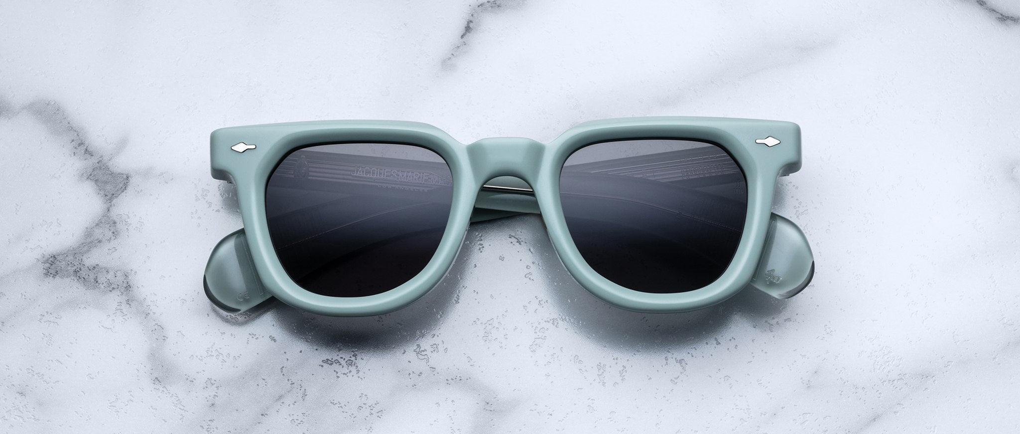 Jacques Marie Mage Vendome square sunglasses with dark lenses, top view, product placed on a flat surface.