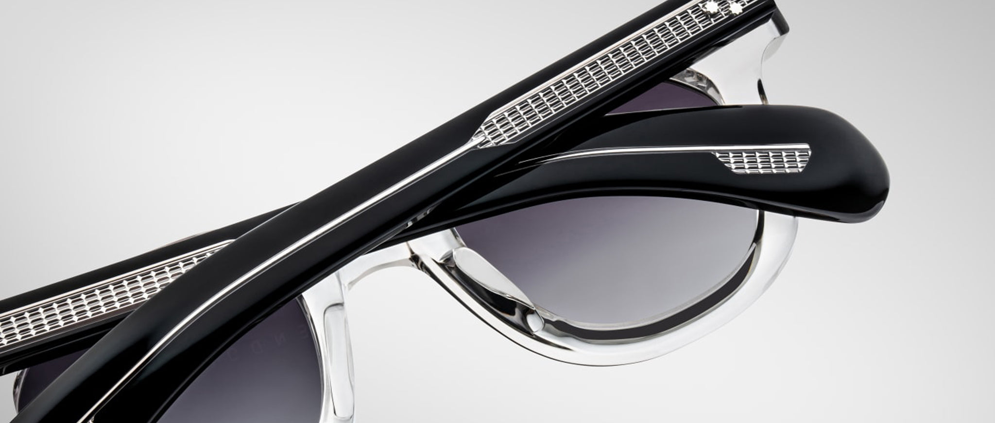 Close-up of Jacques Marie Mage Vendome sunglasses, black and clear frame with silver details, front angle.