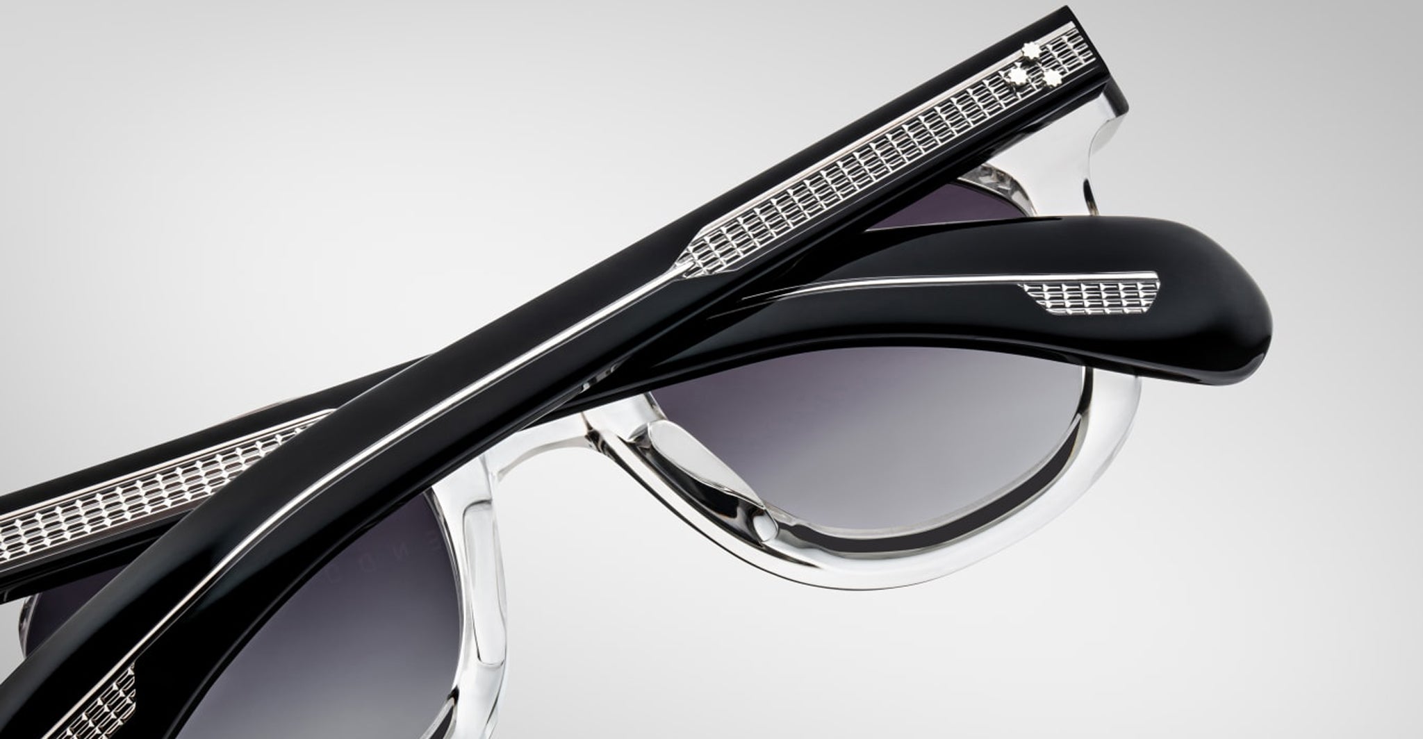 Close-up of folded Jacques Marie Mage Vendome sunglasses, featuring metal detailing on the arms and handcrafted in Japan, set against a plain gray background.