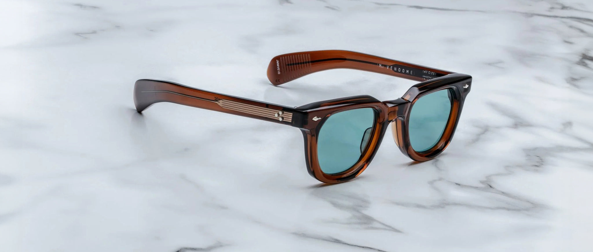 Jacques Marie Mage Vendome sunglasses with blue-tinted lenses shown from above, highlighting frame and lens color.