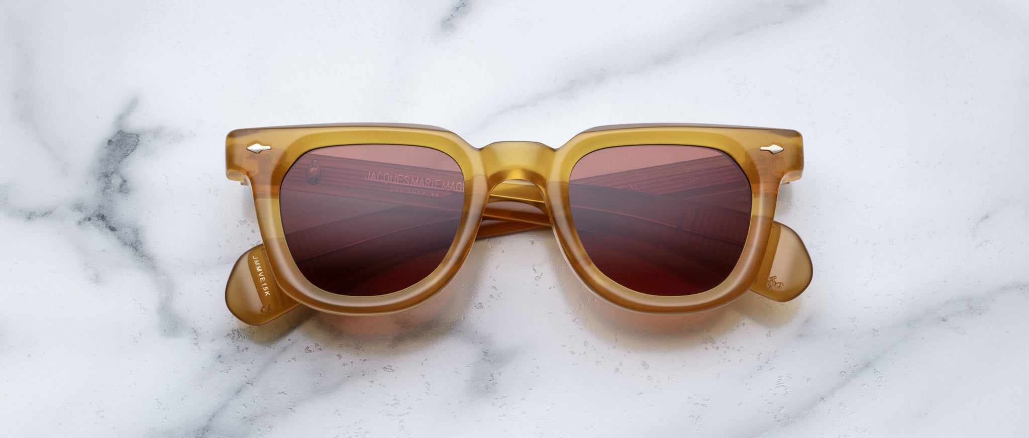 Jacques Marie Mage Vendome brown sunglasses with UV-protected red lenses, shown from above.