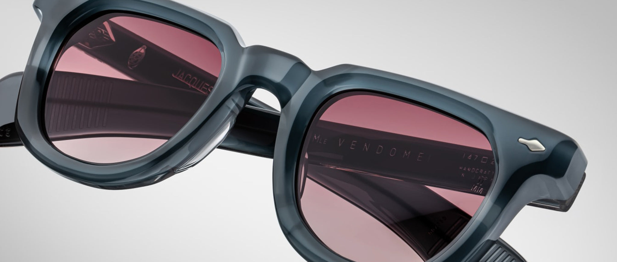Close-up of Jacques Marie Mage Vendome sunglasses, featuring pink lenses and UV protection, shown from the front angle.