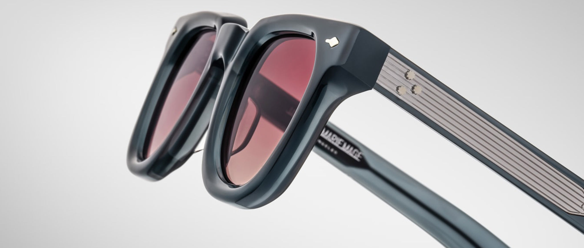 Close-up of Jacques Marie Mage Vendome black sunglasses featuring tinted lenses, metallic accents, and a modern frame design.