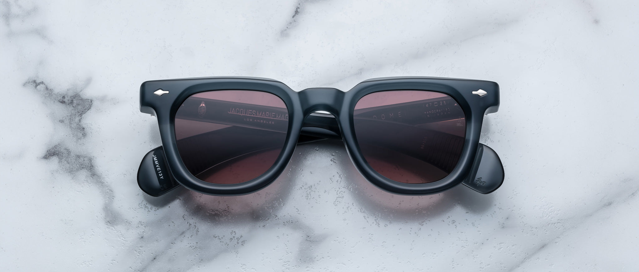 Jacques Marie Mage Vendome sunglasses with black frames and dark lenses, viewed from above.