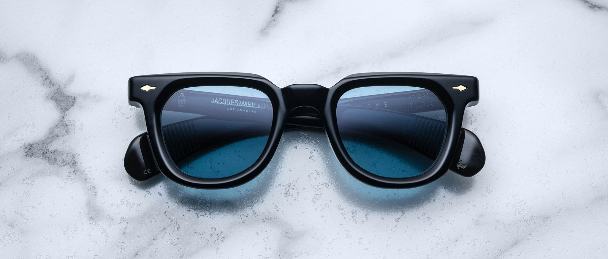 Jacques Marie Mage Vendome black square-frame sunglasses with blue-tinted lenses, top view.