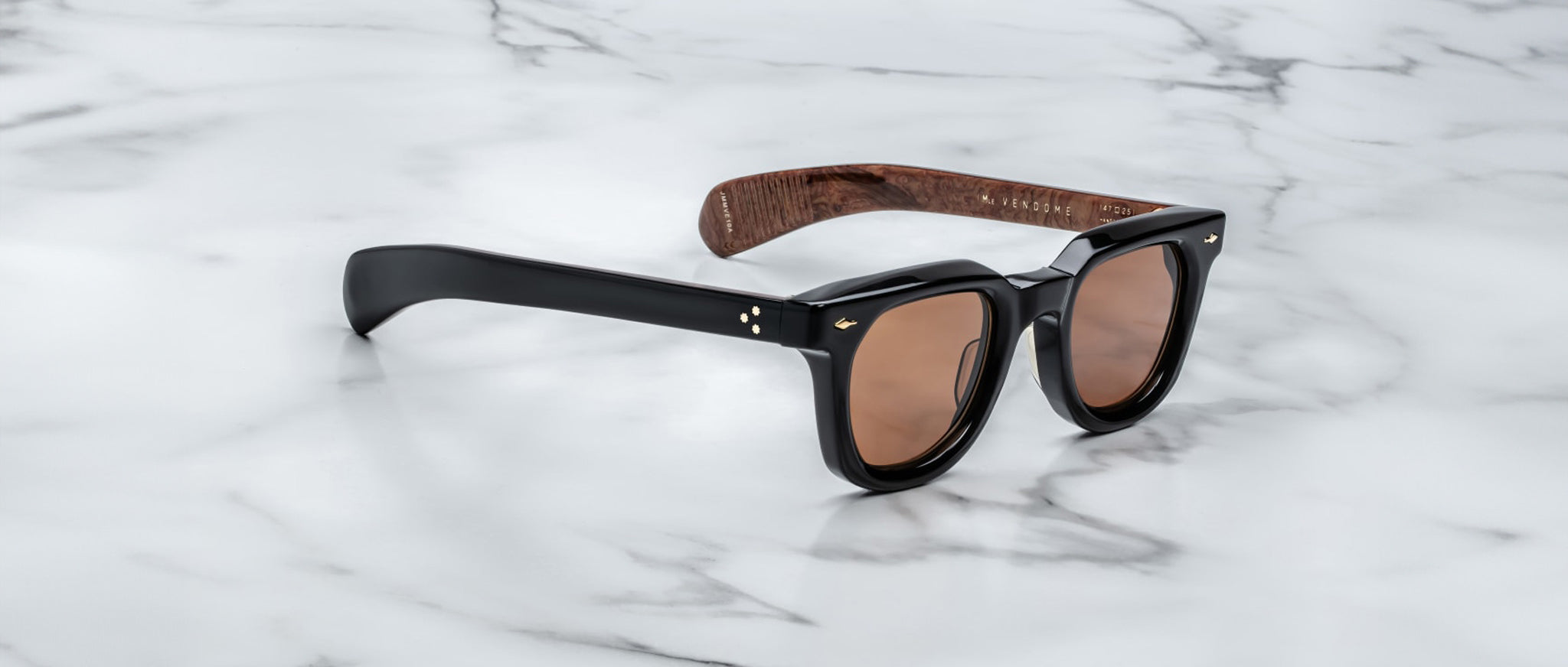 Jacques Marie Mage Vendome sunglasses shown from above, featuring brown lenses and wood-grain arms.
