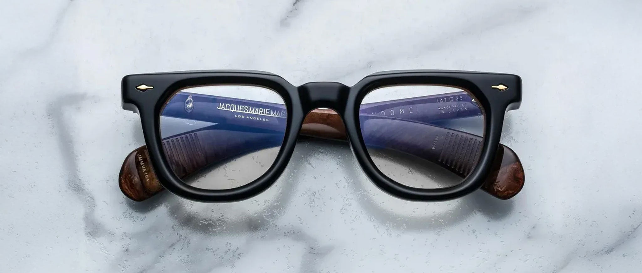 Jacques Marie Mage Vendome black rectangular eyeglasses with brown arms, top view.