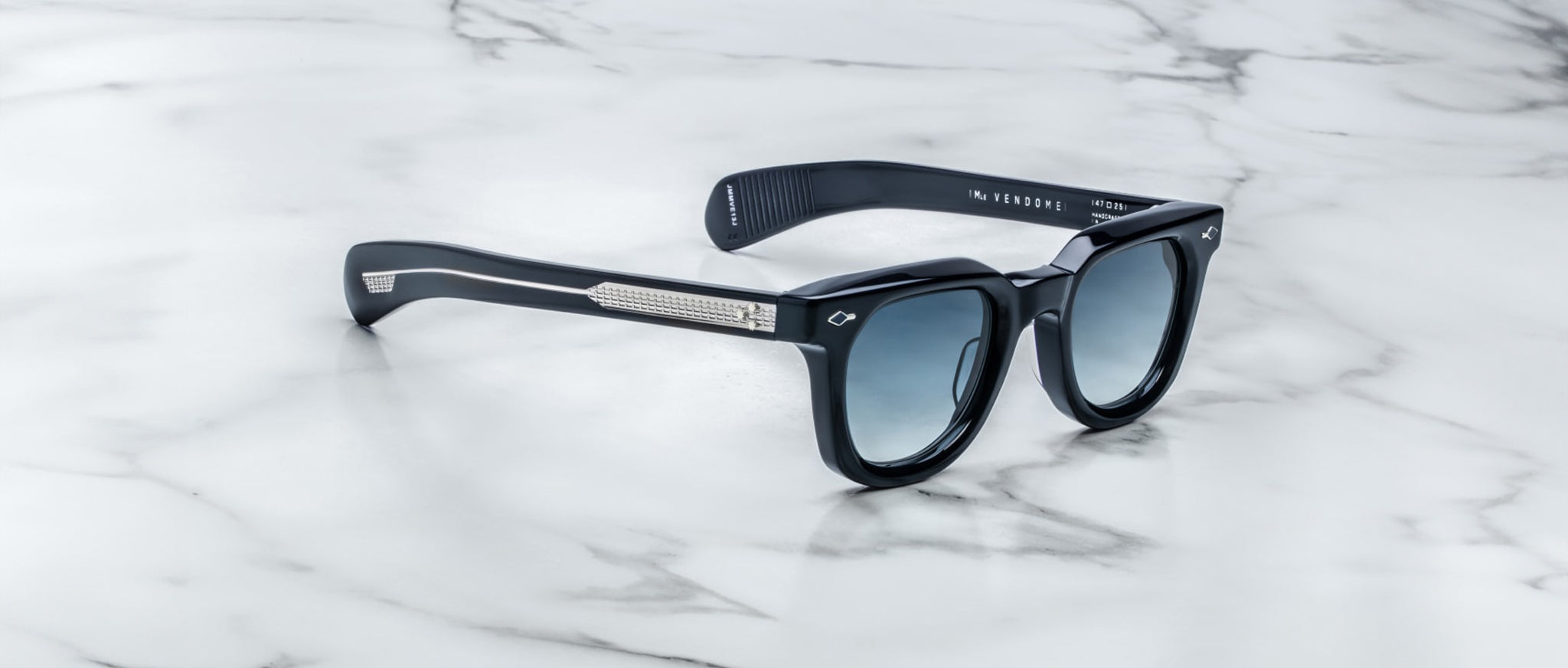 Jacques Marie Mage Vendome sunglasses with blue-tinted lenses and silver arms, shown from above.