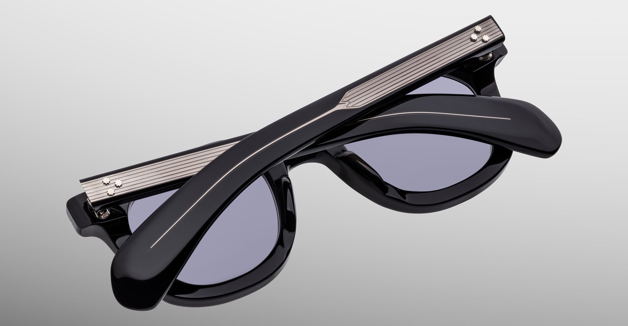 A pair of Jacques Marie Mage Vendome sunglasses with folded arms, handcrafted in Japan, by Jacques Marie Mage, displayed on a light gray background.