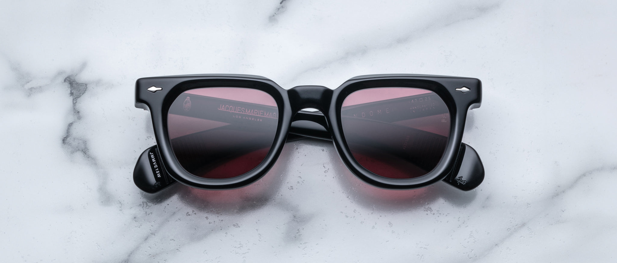 Jacques Marie Mage Vendome sunglasses with black square frames and tinted lenses, shown from above.