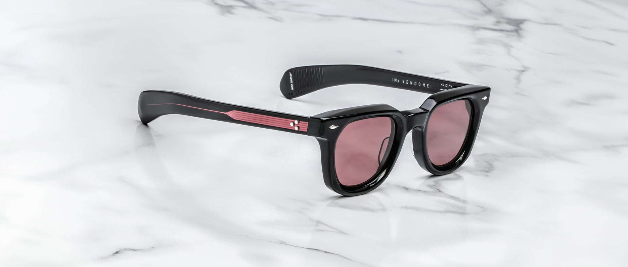 Jacques Marie Mage Vendome black sunglasses with pink lenses and accents, top view.