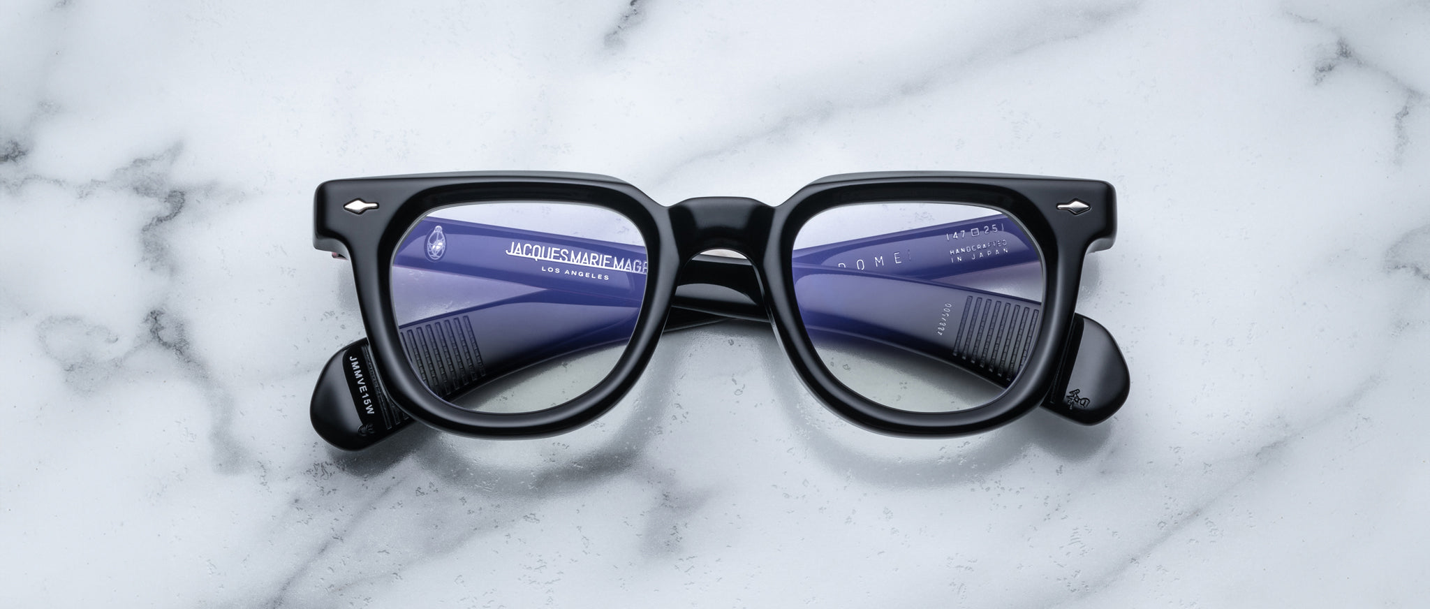 Jacques Marie Mage Vendome eyeglasses, front view, with two black combs visible through the clear lenses.