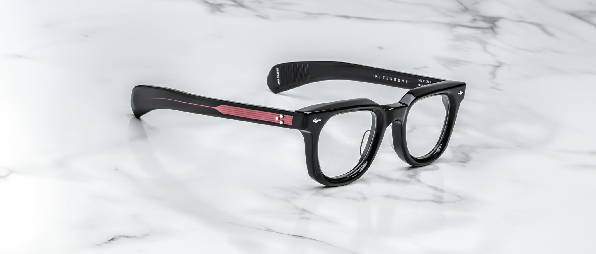 Jacques Marie Mage Vendome black rectangular eyeglasses with red accents, top view.