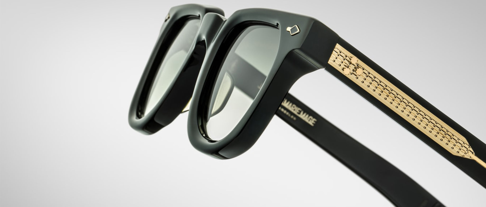 Close-up view of Jacques Marie Mage Vendome black sunglasses, featuring gold-accented temples.