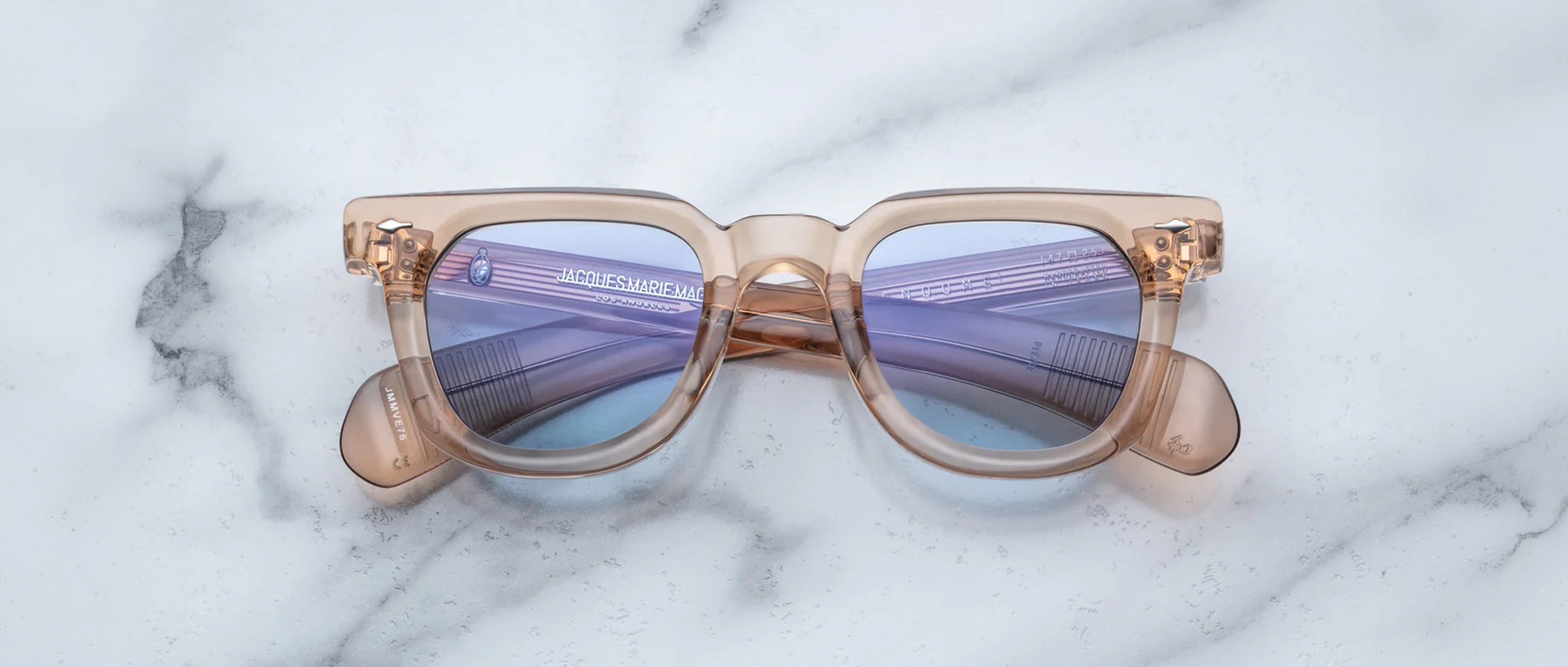 Jacques Marie Mage Vendome beige sunglasses with purple lenses shown from above angle.