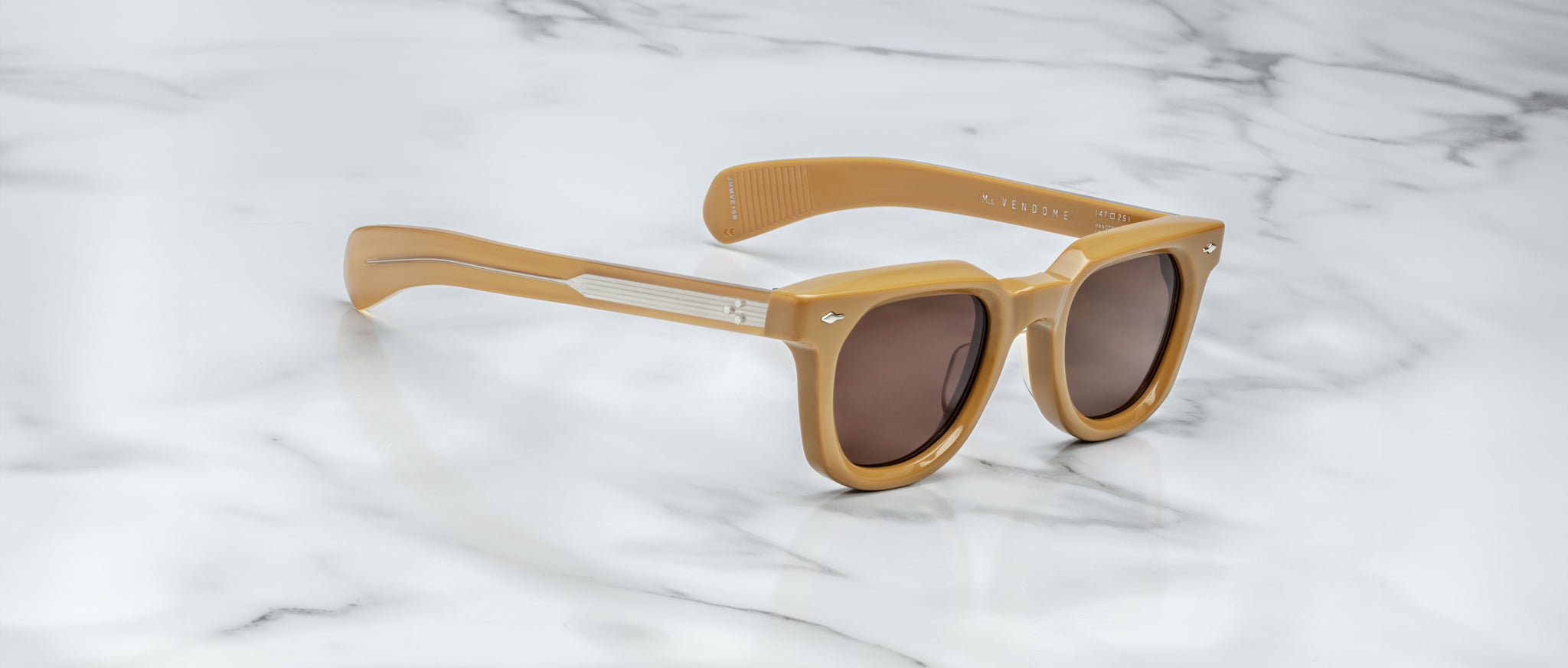 Jacques Marie Mage Vendome tan sunglasses with dark lenses and thick frames shown from above.
