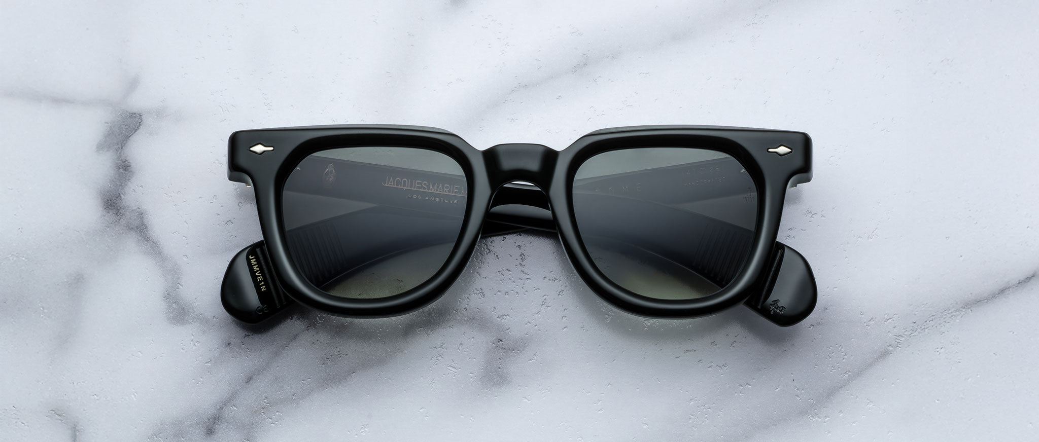 Jacques Marie Mage Vendome black rectangular sunglasses with dark lenses, top view.