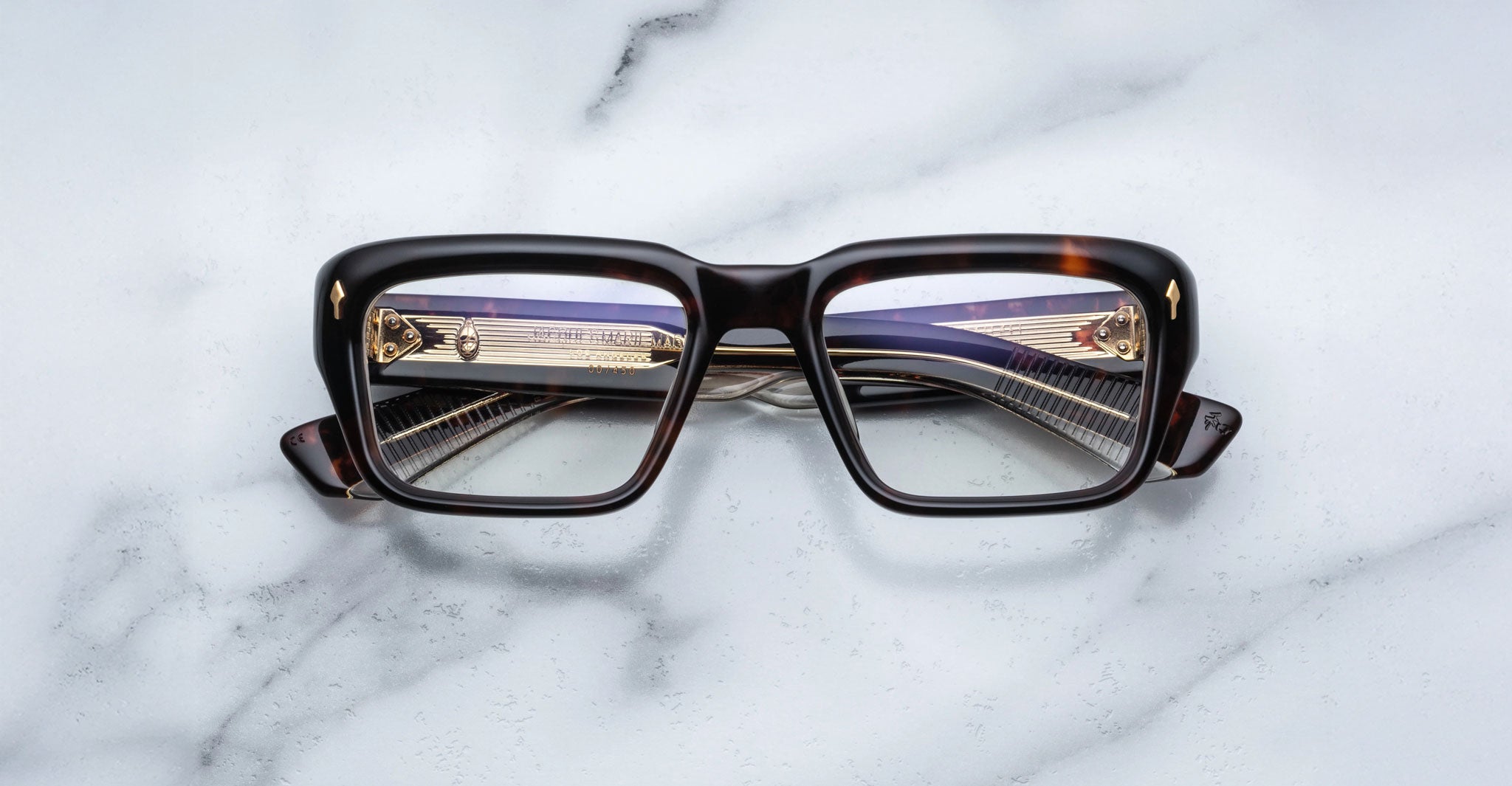 Jacques Marie Mage Walker eyeglasses with rectangular dark brown frames and gold temples, shown from above.