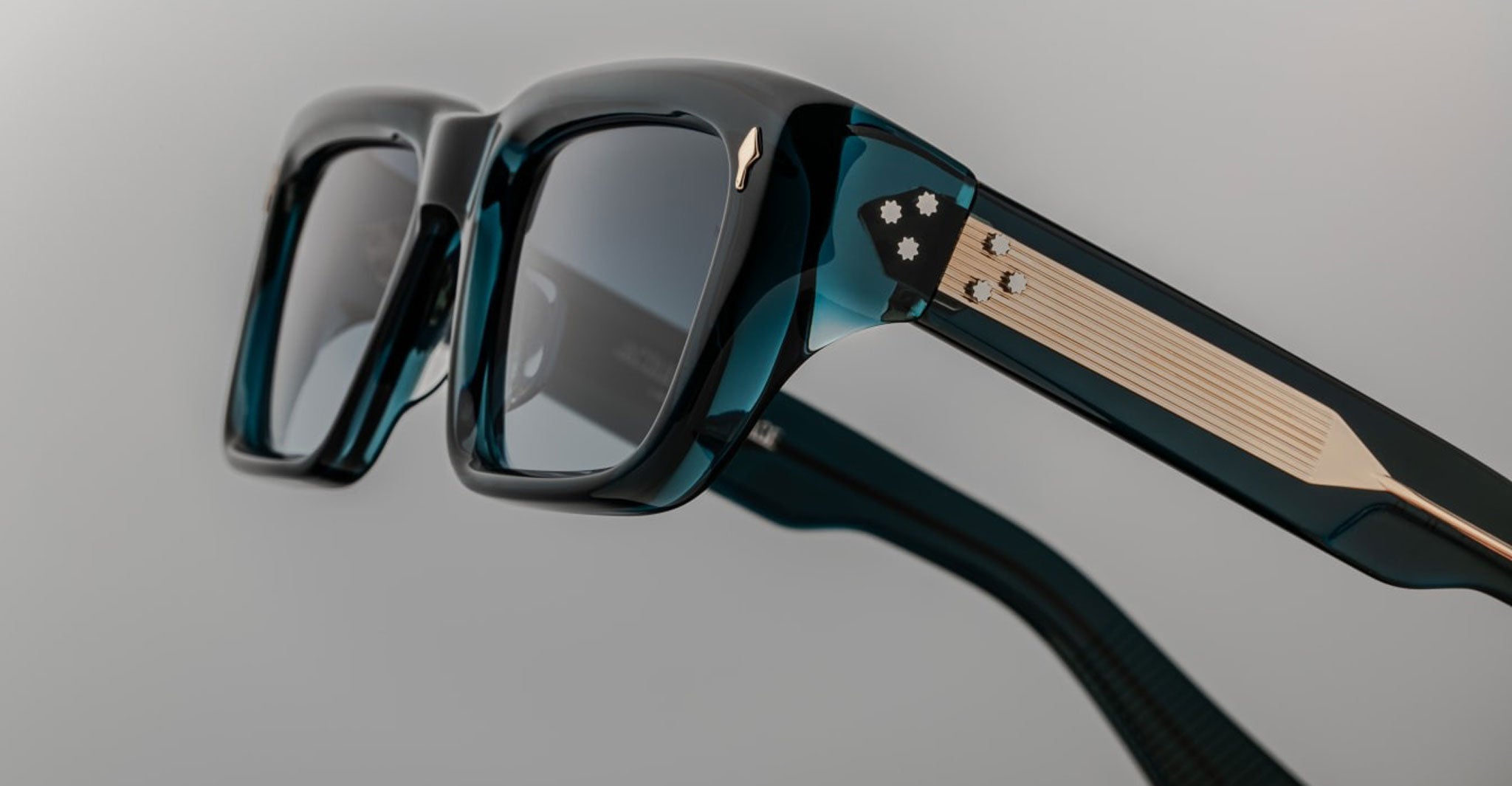 Close-up of Jacques Marie Mage Walker eyeglasses featuring thick dark frames and gold detailing, shown from a frontal angle.