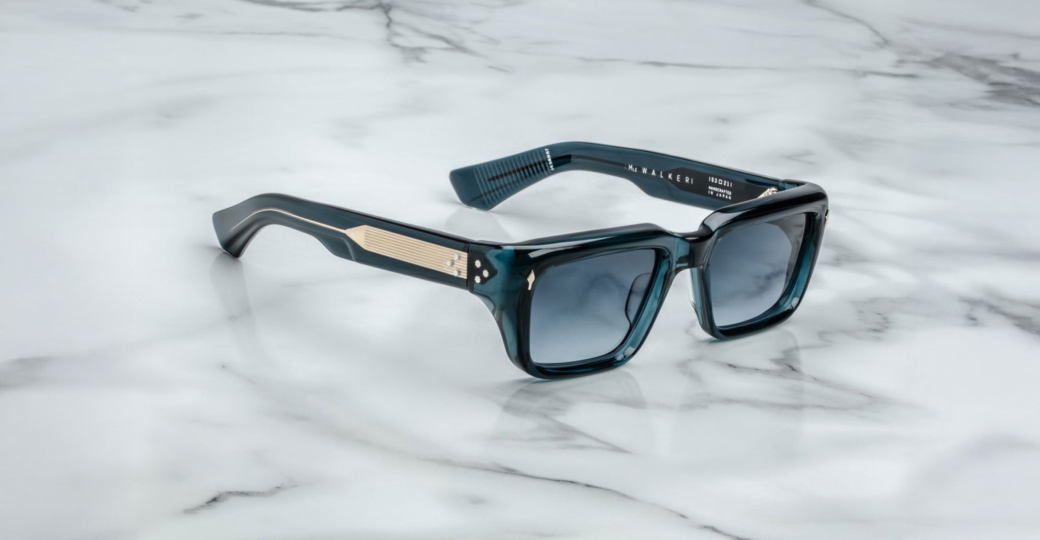 Jacques Marie Mage Walker blue rectangular sunglasses with thick frames and metallic accents, viewed from above.