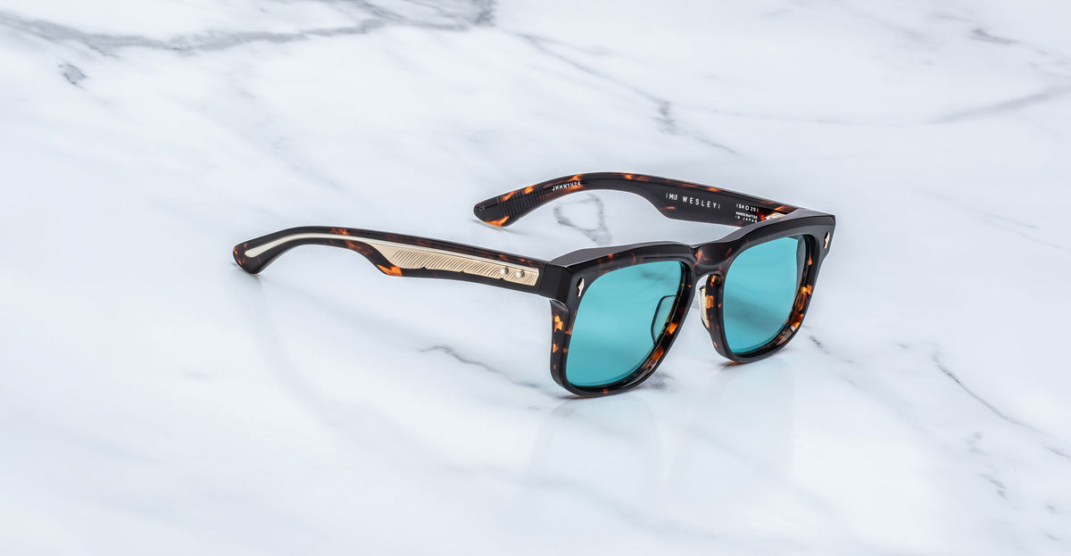 Jacques Marie Mage Wesley sunglasses with teal lenses and gold accents, front view.