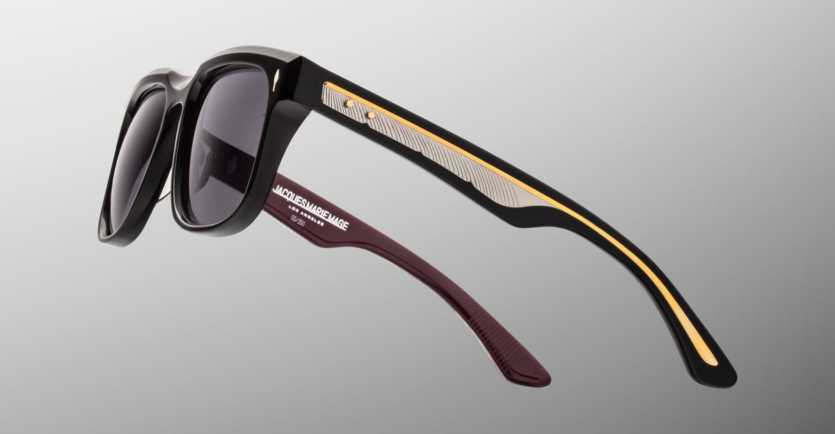 Jacques Marie Mage Wesley black sunglasses with gold and silver arms, shown from the front angle.