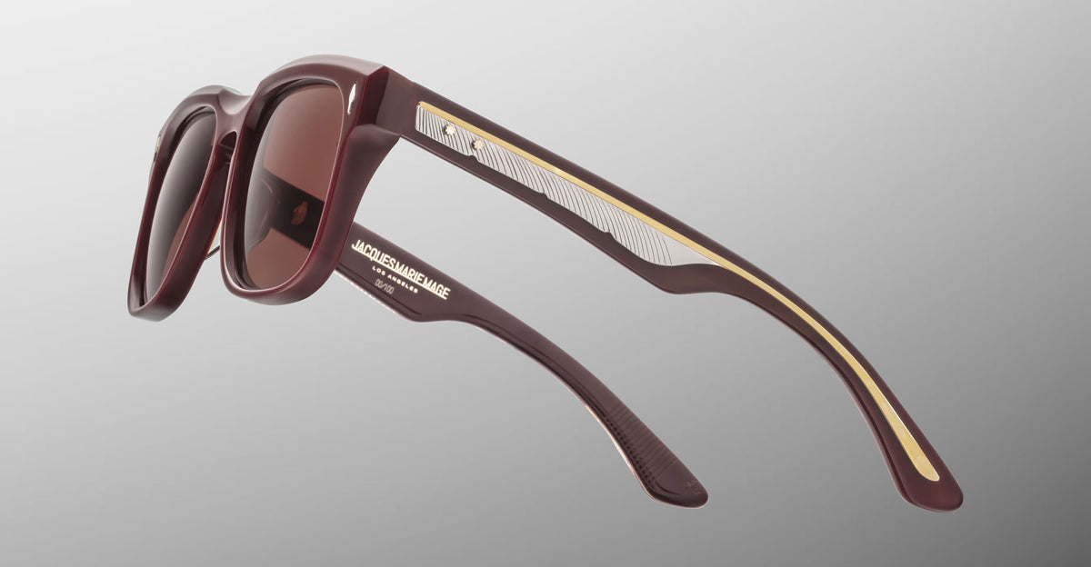 Jacques Marie Mage Wesley sunglasses in maroon with gold accents, side and lens details visible.