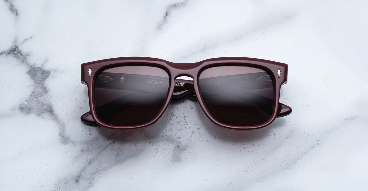 Jacques Marie Mage Wesley burgundy sunglasses with polarized lenses, top-down view.