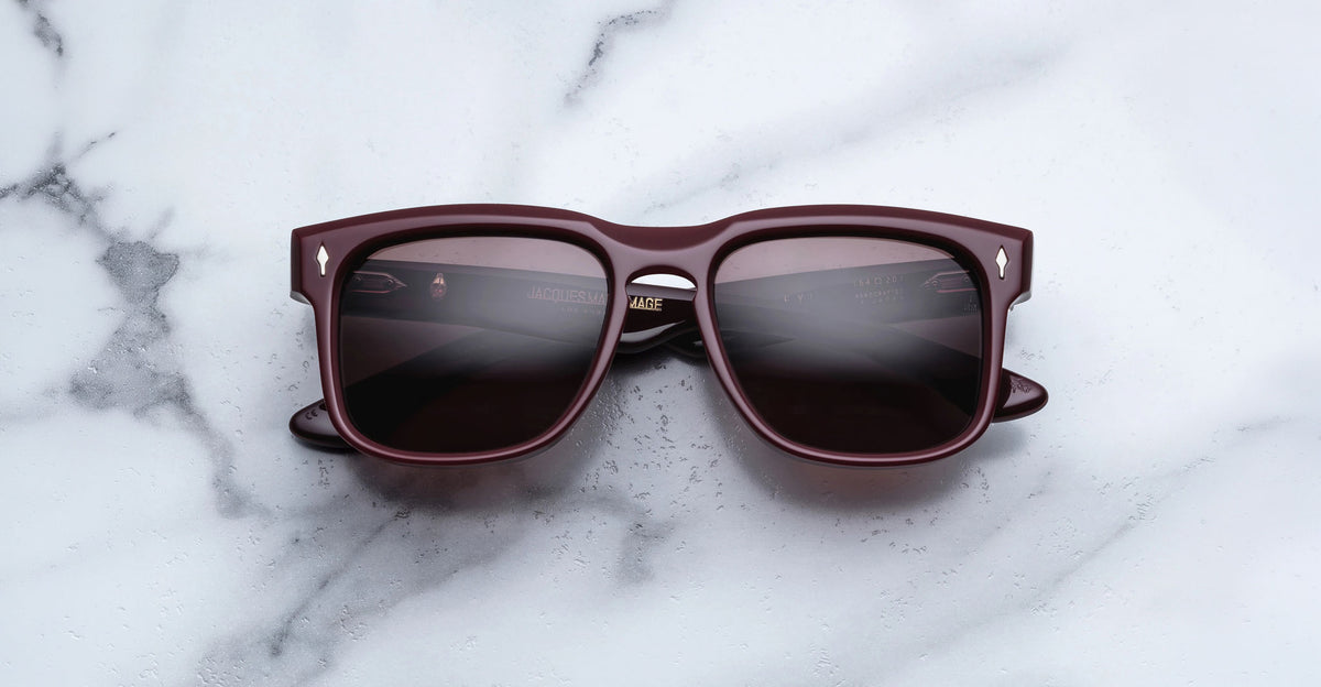 Jacques Marie Mage Wesley burgundy sunglasses with polarized lenses, top-down view.