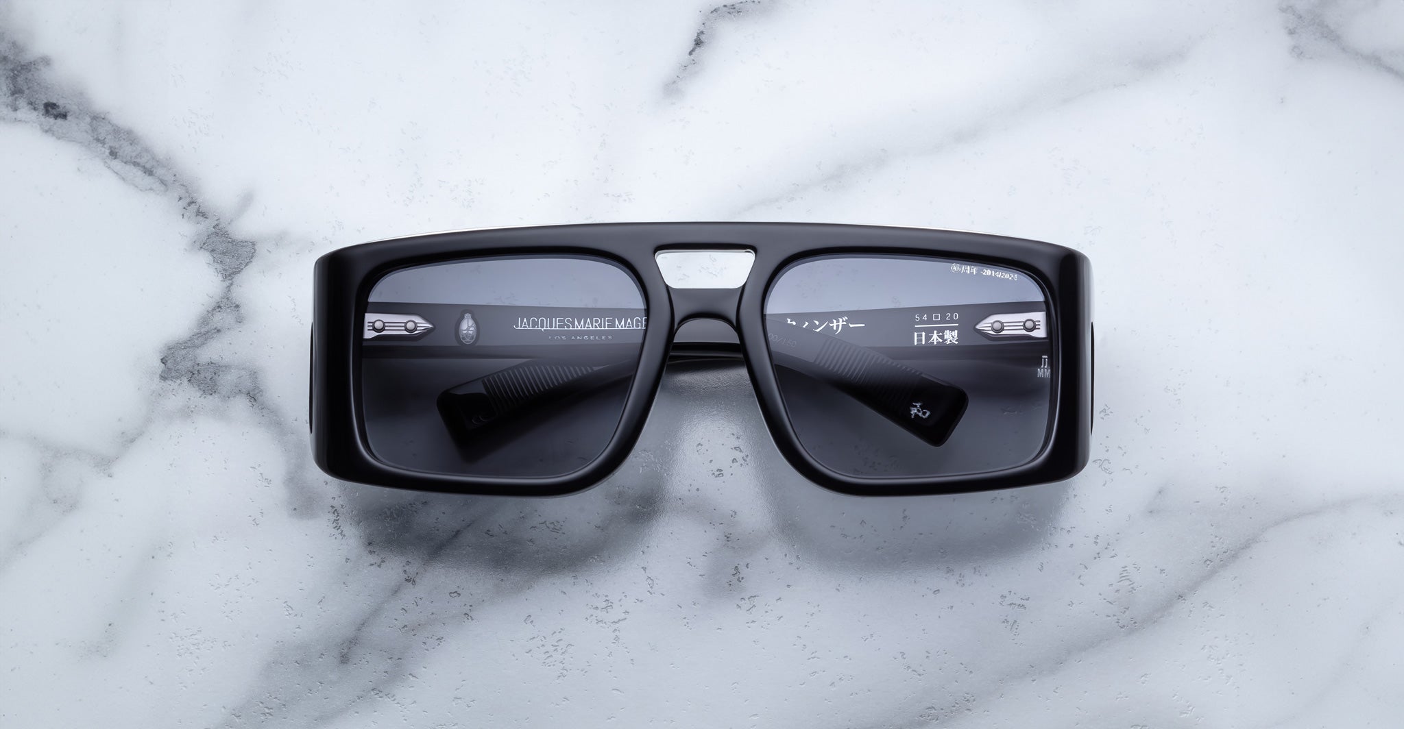 Jacques Marie Mage Windsor black rectangular sunglasses with dark lenses, shown from above.