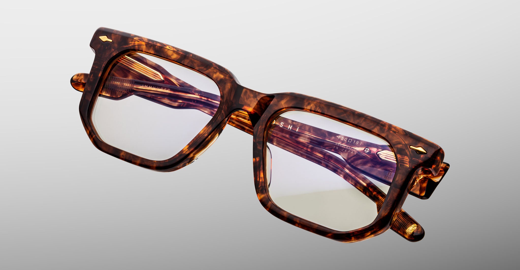 Jacques Marie Mage Yoshi in Argyle acetate optical frame close-up angled view with geometric lens shape and arrowhead pins